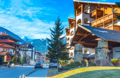 Bansko, Bulgaria - February 19, 2015: Street, people and mountain view in ski resort Bansko, Bulgaria