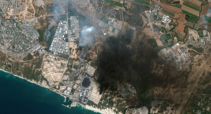 epa09198390 A handout satellite image made available by MAXAR Technologies shows an overview of Ashkelon and a burning storage tank in Southern Israel, 12 May 2021 (issued 13 May 2021). In response to days of violent confrontations between Israeli security forces and Palestinians in Jerusalem, various Palestinian militants factions in Gaza launched rocket attacks since 10 May that killed at least seven Israelis to date. Gaza Strip's health ministry said that at least 100 Palestinians, including 13 children, were killed in the recent retaliatory Israeli airstrikes. Hamas confirmed the death of Bassem Issa, its Gaza City commander, during an airstrike.  EPA/MAXAR TECHNOLOGIES HANDOUT -- MANDATORY CREDIT: SATELLITE IMAGE 2021 MAXAR TECHNOLOGIES -- the watermark may not be removed/cropped -- HANDOUT EDITORIAL USE ONLY/NO SALES
