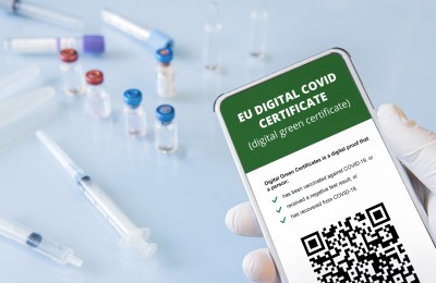 A smartphone with qr code in the app to confirm vaccination or a negative test for covid-19/ all the graphics are made up by author