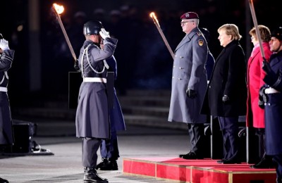 epa09617466 German Chancellor Angela Merkel (3-R) attends the military grand tattoo in her honor at the defense ministry in Berlin, Germany, 02 December 2021. Acting German Chancellor Angela Merkel receives on 02 December 2021, on the occasion of her farewell, a Grand Tattoo of the German Federal Armed Forces (Bundeswehr).  EPA/CLEMENS BILAN