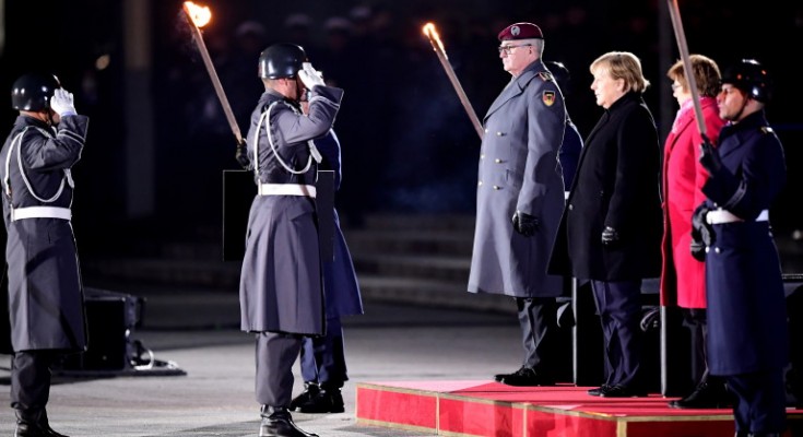 epa09617466 German Chancellor Angela Merkel (3-R) attends the military grand tattoo in her honor at the defense ministry in Berlin, Germany, 02 December 2021. Acting German Chancellor Angela Merkel receives on 02 December 2021, on the occasion of her farewell, a Grand Tattoo of the German Federal Armed Forces (Bundeswehr).  EPA/CLEMENS BILAN