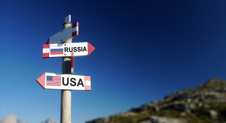 Russian and American flags in two directions on road sign. Relationships and differences in diplomacy, strategy and interests.