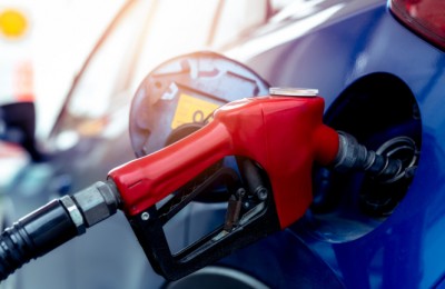 Car fueling at gas station. Refuel fill up with petrol gasoline. Petrol pump filling fuel nozzle in fuel tank of car at gas station. Petrol industry and service. Petrol price and oil crisis concept.