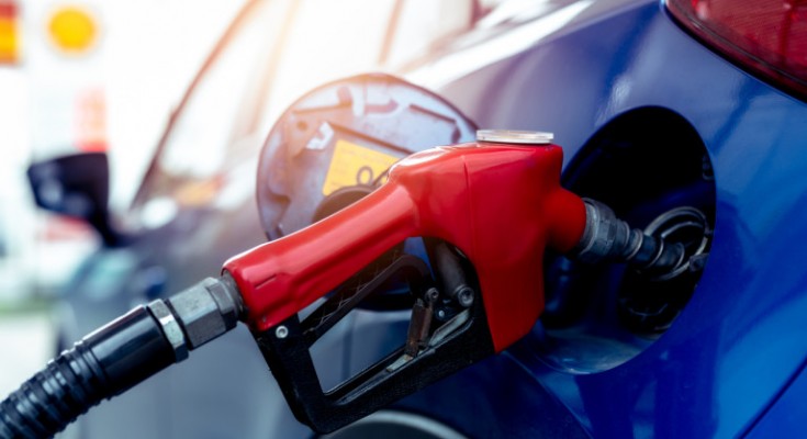 Car fueling at gas station. Refuel fill up with petrol gasoline. Petrol pump filling fuel nozzle in fuel tank of car at gas station. Petrol industry and service. Petrol price and oil crisis concept.