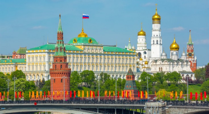 View of Moscow Kremlin behind the Bolshoy Kamenny Bridge with bright flags