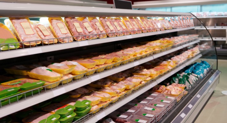 Fresh chicken meat on supermarket shelf, all logos removed