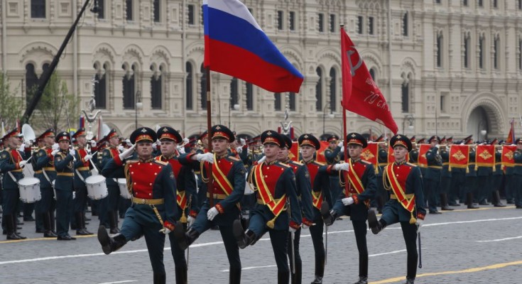 epa07557061 Russian honor guards with a national flag and a replica of a flag raised on the roof of Reichstag march during Victory Day parade in Red Square in Moscow, Russia, 09 May 2019. Russia marks 09 May the 74th anniversary of the victory in the World War II over Nazi Germany and its allies. The Soviet Union lost 27 million people in the war.  EPA/YURI KOCHETKOV