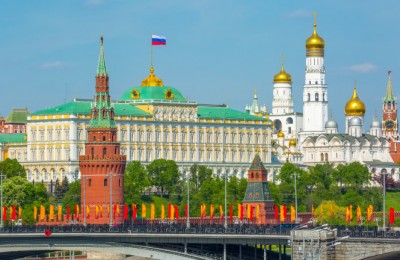View of Moscow Kremlin behind the Bolshoy Kamenny Bridge with bright flags