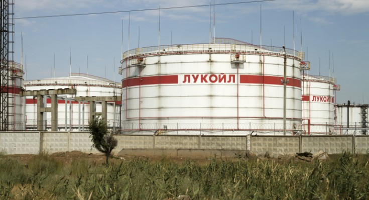 Volgograd, Russia - August 28, 2015:  Huge storage tanks for petroleum products with the logo of LUKOIL on the background of a large refinery