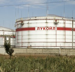 Volgograd, Russia - August 28, 2015:  Huge storage tanks for petroleum products with the logo of LUKOIL on the background of a large refinery