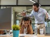Male and female Office employees having argument at workplace.