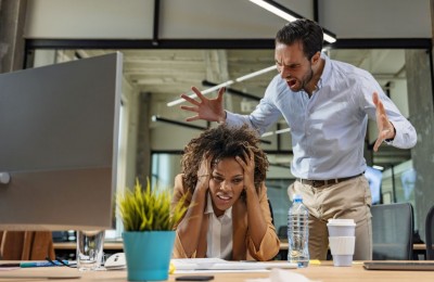 Male and female Office employees having argument at workplace.