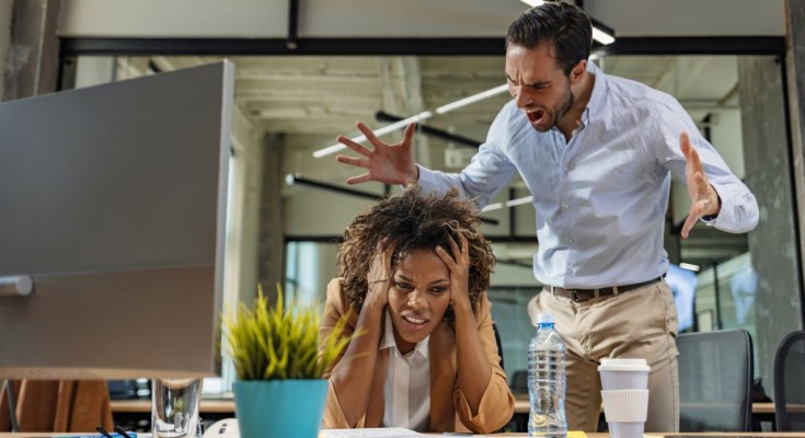 Male and female Office employees having argument at workplace.