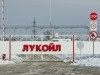 Volgograd, Russia - February 7, 2014: Automatic gates at the checkpoint with the inscription LUKOIL. Entry to the territory of the Volgograd oil depots through a checkpoint